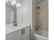 Clean bathroom featuring a vanity sink, a shower-tub, and neutral wall color at 945 N Fern Creek Ave, Orlando, FL 32803