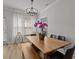 Dining room with a large wood table, modern chandelier, and natural light from large window at 945 N Fern Creek Ave, Orlando, FL 32803