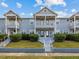 Charming two-story townhouse with well-maintained landscaping, front balcony and inviting entrance at 945 N Fern Creek Ave, Orlando, FL 32803