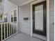 Charming front entrance showcases a black front door, light-gray siding, and white trim at 945 N Fern Creek Ave, Orlando, FL 32803