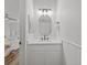 Stylish powder room features a modern oval mirror, vanity, and crisp white finishes at 945 N Fern Creek Ave, Orlando, FL 32803