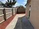 Backyard featuring a fenced perimeter, a red mulch border, and a stone path for outdoor enjoyment at 1002 Stucki Ter, Winter Garden, FL 34787