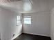 Bright bedroom with white wood paneling, and dark wood floors at 1002 Stucki Ter, Winter Garden, FL 34787