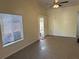 An empty living room with a ceiling fan and sliding glass door at 1002 Stucki Ter, Winter Garden, FL 34787