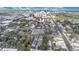 Arial shot of residences with a city skyline, commercial buildings, lush trees, and traffic in the background at 11 W Harding St # D, Orlando, FL 32806