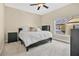 Bedroom featuring neutral walls, ceiling fan, and large window for natural light at 11 W Harding St # D, Orlando, FL 32806