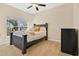 Bedroom featuring neutral walls, ceiling fan, and large window for natural light at 11 W Harding St # D, Orlando, FL 32806