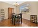 Cozy dining room featuring hardwood floors, a wooden table set, and natural light at 11 W Harding St # D, Orlando, FL 32806