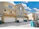 Exterior view of townhomes with garages and well-maintained landscaping at 11 W Harding St # D, Orlando, FL 32806