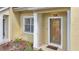 Front entrance featuring a decorative glass door with sidelight, window, and a welcoming doormat on the porch at 11 W Harding St # D, Orlando, FL 32806