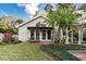 Charming home exterior featuring a well-manicured lawn and outdoor seating, perfect for entertaining at 1100 S Lake Sybelia Dr, Maitland, FL 32751