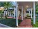 Walkway featuring a covered outdoor walkway with brick-paved path and beautiful landscaping at 1100 S Lake Sybelia Dr, Maitland, FL 32751