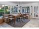 Bright dining room featuring a built-in bench, wood table, and large windows offering a garden view at 1100 S Lake Sybelia Dr, Maitland, FL 32751