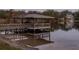 Waterfront dock featuring a covered boat lift, creating easy access to the serene lake at 1100 S Lake Sybelia Dr, Maitland, FL 32751