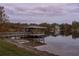 Picturesque view of the covered boat dock on the lake, offering peaceful waterfront living at 1100 S Lake Sybelia Dr, Maitland, FL 32751