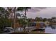 A beautiful waterfront view with a boat dock surrounded by tropical foliage and serene water at 1100 S Lake Sybelia Dr, Maitland, FL 32751