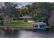 Beautiful waterfront home with lush landscaping and a private boat dock at 1100 S Lake Sybelia Dr, Maitland, FL 32751