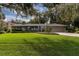 Well-maintained single-story home featuring a manicured front lawn and attached two-car garage at 1100 S Lake Sybelia Dr, Maitland, FL 32751