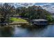 Exterior shot featuring the waterfront home with a covered dock and access to the calm lake at 1100 S Lake Sybelia Dr, Maitland, FL 32751