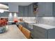 Bright kitchen featuring grey cabinets, marble countertops, and stainless steel appliances at 1100 S Lake Sybelia Dr, Maitland, FL 32751