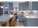 Stylish kitchen featuring a stainless steel range, farmhouse sink, and elegant marble countertops at 1100 S Lake Sybelia Dr, Maitland, FL 32751