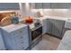 Elegant kitchen showcasing marble countertops, stainless steel oven, and gray cabinetry at 1100 S Lake Sybelia Dr, Maitland, FL 32751