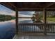 Breathtaking lake view from the wooden gazebo shows tranquil water and a vibrant horizon at 1100 S Lake Sybelia Dr, Maitland, FL 32751