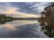 Picturesque lake reflecting the beautiful cloudscape and shoreline, creating a serene view at 1100 S Lake Sybelia Dr, Maitland, FL 32751