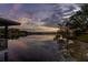 Scenic lake view from dock, capturing the tranquil waters and distant homes at sunset at 1100 S Lake Sybelia Dr, Maitland, FL 32751