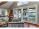 Living room with a vaulted ceiling and multiple French doors at 1100 S Lake Sybelia Dr, Maitland, FL 32751