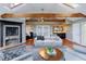 Cozy living room with exposed wood beams, fireplace, and flooded with natural light from skylights at 1100 S Lake Sybelia Dr, Maitland, FL 32751