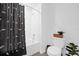 Well-lit bathroom with a shower and tub combo, decorated with green plants and accessories at 1139 James Paul Rd, Davenport, FL 33837