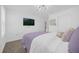 Bedroom featuring carpet floors, white and purple bedding, and a mounted television at 1139 James Paul Rd, Davenport, FL 33837