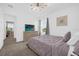 Bedroom featuring carpet floors, gray bedding, side tables with lamps and a mounted television at 1139 James Paul Rd, Davenport, FL 33837