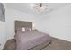 Bedroom with carpet, large window, gray upholstered headboard, and a mid-century modern light fixture at 1139 James Paul Rd, Davenport, FL 33837