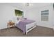 Cozy bedroom with purple bedding, side table with lamps, and a large window at 1139 James Paul Rd, Davenport, FL 33837