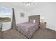 Bedroom featuring carpet floors, gray bedding, bedside tables and natural light at 1139 James Paul Rd, Davenport, FL 33837