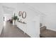 Bright hallway featuring tile flooring, wall decor, storage cabinet and staircase with safety gate at 1139 James Paul Rd, Davenport, FL 33837