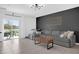 Bright living room featuring a gray sectional sofa, modern lighting, and sliding door to patio at 1139 James Paul Rd, Davenport, FL 33837