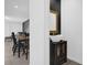 Stylish powder room with a vessel sink, modern fixtures, dark accent wall and access to dining area at 1139 James Paul Rd, Davenport, FL 33837