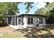 Back exterior view of home with screened porch, yard and new AC system at 117 Shannon Dr, Sanford, FL 32773