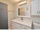 Bathroom featuring a white vanity with quartz countertop, white cabinets, and shower-tub combo at 117 Shannon Dr, Sanford, FL 32773