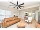 Open living room with hardwood floors, view to the kitchen, modern furnishings, and bright light at 117 Shannon Dr, Sanford, FL 32773