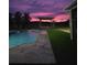 Twilight view of the pool and backyard at 12625 Sweet Hill Rd, Polk City, FL 33868