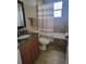 Bathroom with a wood vanity, granite countertop, tile flooring, a toilet and a shower tub combo at 12625 Sweet Hill Rd, Polk City, FL 33868