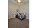 A neutral bedroom with carpeted floors and a black metal bed frame at 12625 Sweet Hill Rd, Polk City, FL 33868