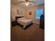 A carpeted bedroom featuring a bed, side table, and a large window at 12625 Sweet Hill Rd, Polk City, FL 33868