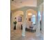 Formal dining room featuring elegant archways, neutral decor, and large windows at 12625 Sweet Hill Rd, Polk City, FL 33868