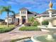 Stunning two-story home featuring manicured landscaping and elegant fountain in the front yard at 12625 Sweet Hill Rd, Polk City, FL 33868