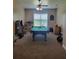 Spacious game room featuring a pool table and windows overlooking the backyard at 12625 Sweet Hill Rd, Polk City, FL 33868